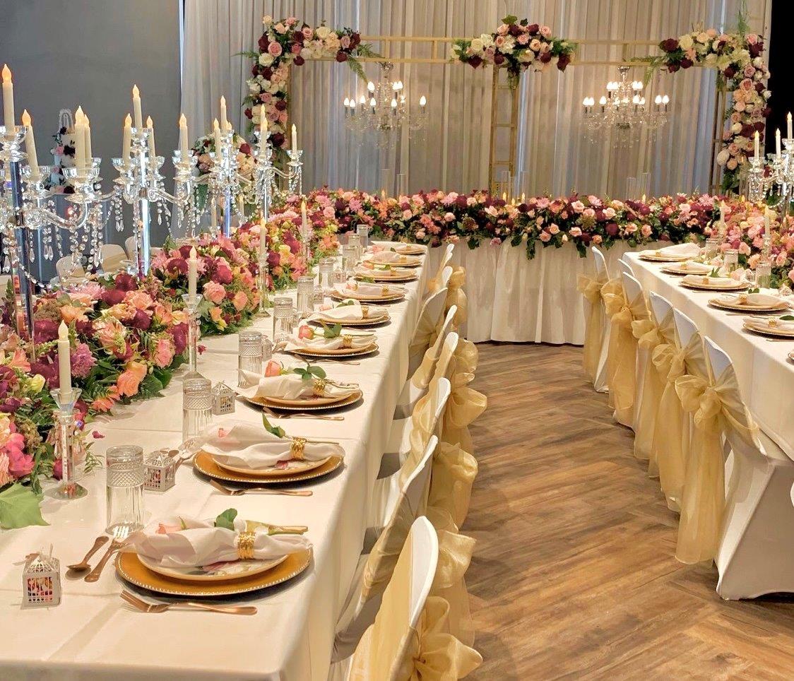Wedding table with tall candles and glassware